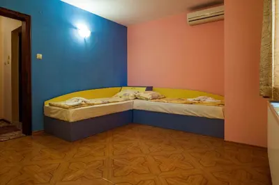 a small bedroom with two beds in a room at Hotel Orchidea in Sozopol