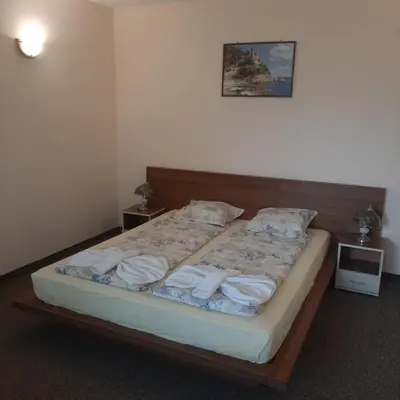 a bedroom with a bed with towels on it at Hotel Orchidea in Sozopol