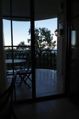 a room with a table and a view of a balcony at Beautiful 1st-Line Seaview Private Appartement in The Cliff resort in Obzor