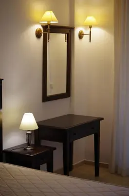 a desk with a mirror and a lamp on a wall at Beautiful 1st-Line Seaview Private Appartement in The Cliff resort in Obzor