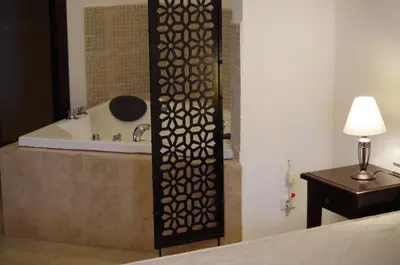 a bathroom with a bath tub and a shower with a table at Beautiful 1st-Line Seaview Private Appartement in The Cliff resort in Obzor