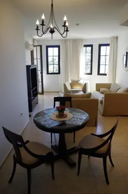 a living room with a table and chairs at Beautiful 1st-Line Seaview Private Appartement in The Cliff resort in Obzor