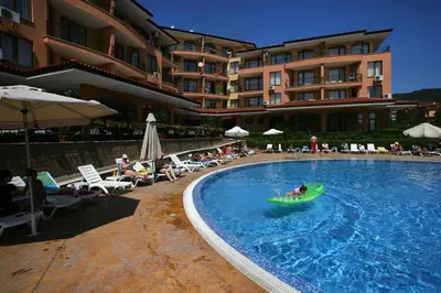 a swimming pool with a person in a raft in the water at Apartcomplex Panorama Dreams in Sveti Vlas
