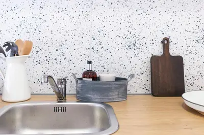 a kitchen counter with a sink and a wall at Balabanov White in Varna City