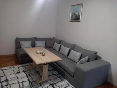 a living room with a couch and a table at Sweet Home in Burgas City