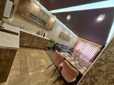 a kitchen and living room with a table and chairs at MitProt Panorama Bay 2 luks Apartment ap100 in Sveti Vlas