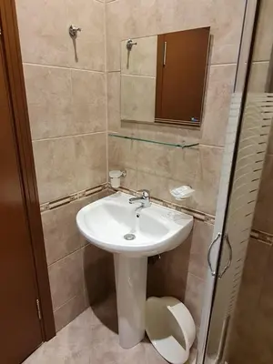 a bathroom with a sink and a mirror and a toilet at MitProt Panorama Bay 2 luks Apartment ap100 in Sveti Vlas