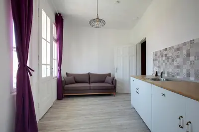 a kitchen with a couch in the corner of a room at Hostel Musala in Varna City