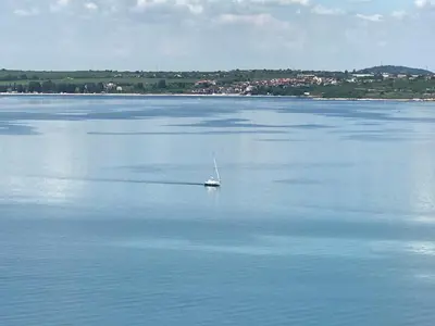 a small boat in the middle of a large body of water at Villa Victoria - a luxury appartment with icredible Seaview in Sozopol