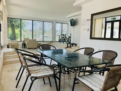 a dining room with a glass table and chairs at Villa Adrian in Shkorpilovtsi