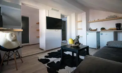 a living room with a couch and a table at Cherry Garden Apartments in Sveti Vlas