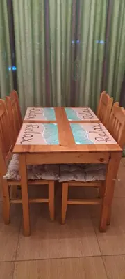 a wooden table with four chairs around it at Grand Kameliq in Sunny Beach