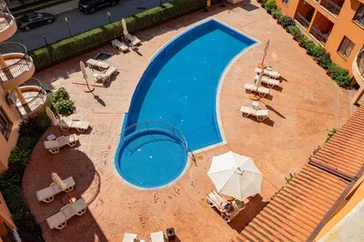 an overhead view of a swimming pool with chairs and umbrellas at Efir 2 - Menada Apartments in Sunny Beach