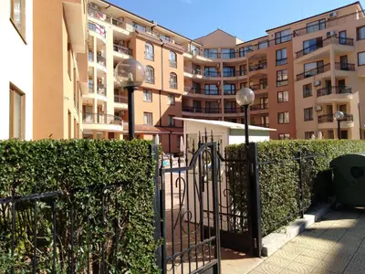 a gate in front of a fence with buildings at Efir 2 - Menada Apartments in Sunny Beach