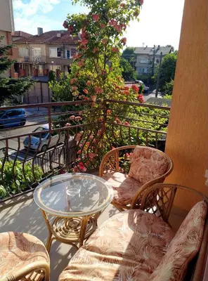 a patio with a glass table and chairs on a balcony at Laura in Primorsko