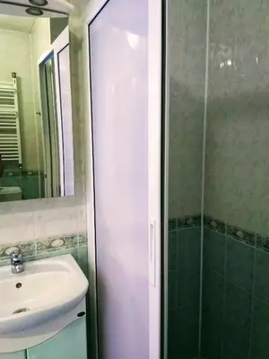 a bathroom with a shower and a sink and a mirror at Laura in Primorsko