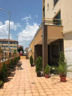 a courtyard of a building with potted plants at Golden Sun in Pomorie