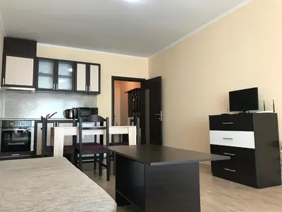 a kitchen with a table and a dining room at Golden Sun in Pomorie
