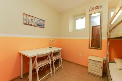 a room with a table and chairs and a mirror at Nomado Hostel in Varna City