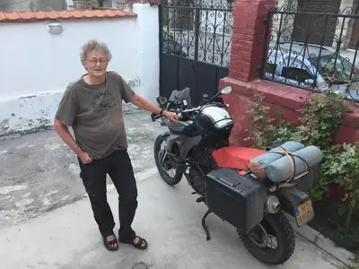 a man is standing next to a motorcycle at Nomado Hostel in Varna City