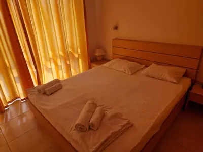 a bedroom with a bed with towels on it at Sun Village Family Houses in Byala