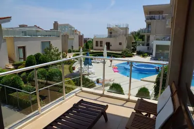 a balcony with a view of a swimming pool at Sun Village Family Houses in Byala