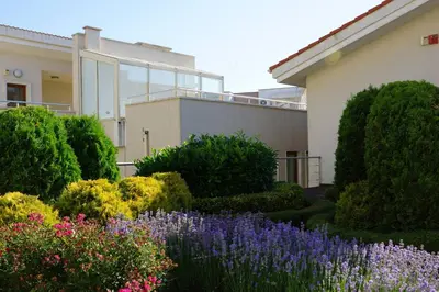 a garden with flowers in front of a building at Sun Village Family Houses in Byala