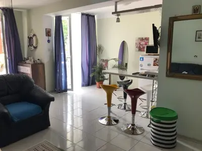 a living room with a couch and a mirror at Alice Apartment in Obzor