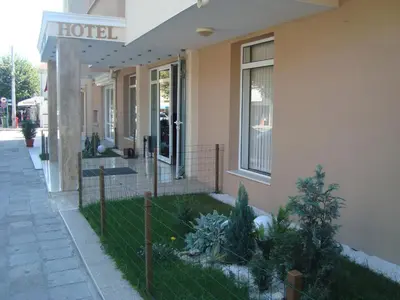 a hotel with a fence in front of a building at Hotel Astra in Ravda