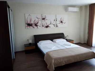 a bedroom with a bed and two paintings on the wall at Gradina in Chernomorets