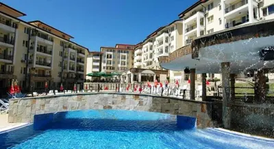 a swimming pool in front of a building at Sunny Beach Hills - Menada Apartments in Sunny Beach