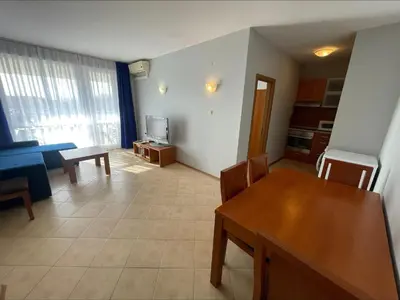 a living room with a table and a television at Sunny Beach Hills - Menada Apartments in Sunny Beach