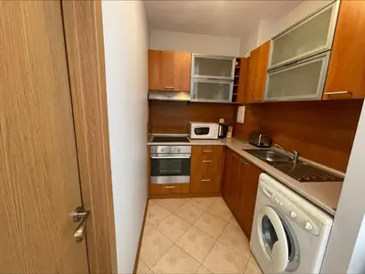 a small kitchen with a stove and a microwave at Sunny Beach Hills - Menada Apartments in Sunny Beach