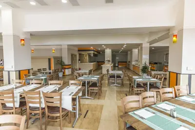 an empty dining room with tables and chairs at Kuban Resort & Aquapark - All Inclusive in Sunny Beach