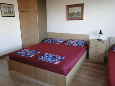 a bedroom with a bed with two pillows on it at Дом Христови in Chernomorets