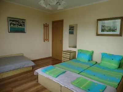 a bedroom with two beds with blue and green pillows at Дом Христови in Chernomorets