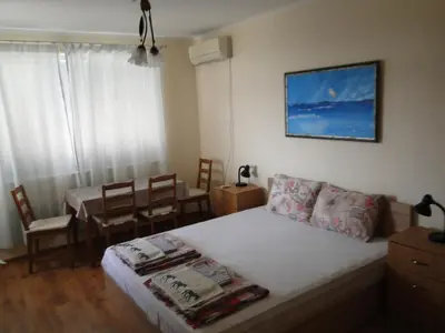 a bedroom with a bed and a table and chairs at Дом Христови in Chernomorets