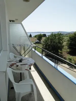 a balcony with a table and chairs and a view at Дом Христови in Chernomorets