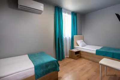a small room with two beds and a window at Sea View Hills in Sveti Vlas