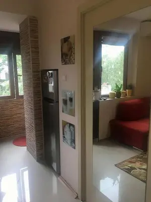 a kitchen with a stainless steel refrigerator in a room at Apartament Peyo Yavorov in Burgas City