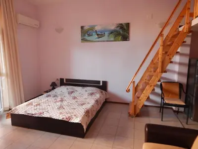 a bedroom with a bed and a stair case at Dunav Str. in Ravda