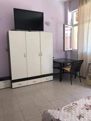 a large white cabinet with a television on top of it at Dunav Str. in Ravda
