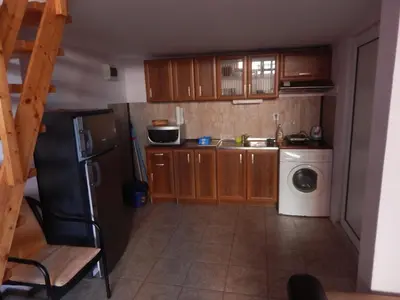 a small kitchen with a refrigerator and a dishwasher at Dunav Str. in Ravda