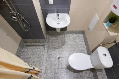 a bathroom with a white toilet and a sink at Vera by RV Apartments in Varna City
