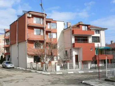 an apartment building with a car parked in front of it at Guest House Galema in Obzor