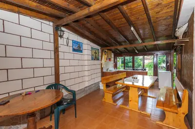 a room with a table and a table and chairs at Guest House Galema in Obzor