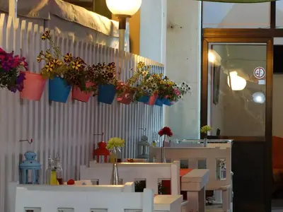 a group of potted plants hanging on a wall at Familia Fantastiko in Kiten