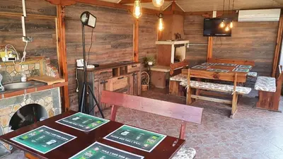 a room with a kitchen and a table and a tv at Family Hotel Kedara in Burgas City