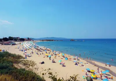 a crowd of people on a beach with the ocean at Apartment Lozenets in Lozenets