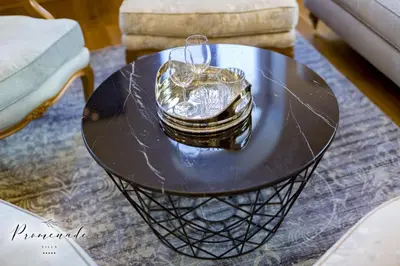 a black coffee table with a gold container on it at Villa Promenade in Burgas City